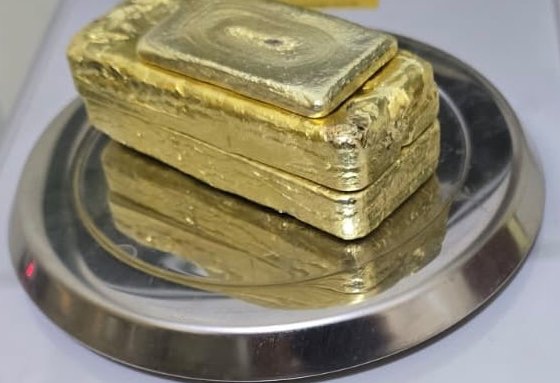 Recovered gold bars on a weighing pan